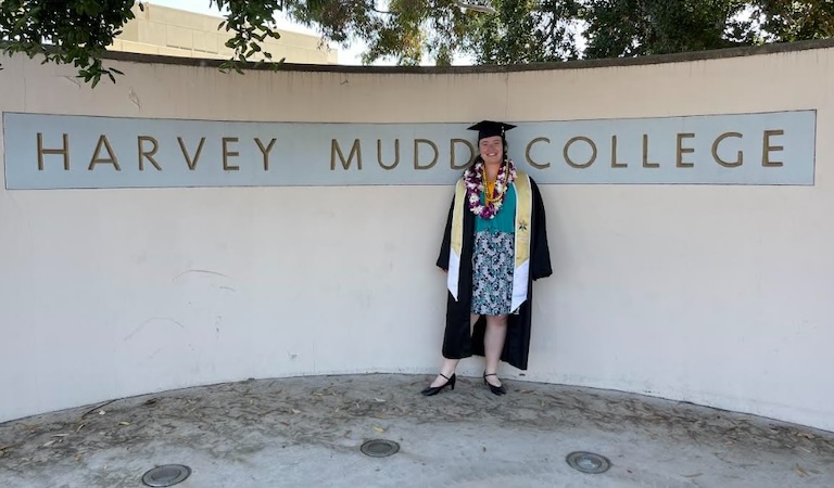 Malia with the Harvey Mudd sign after her graduation.
