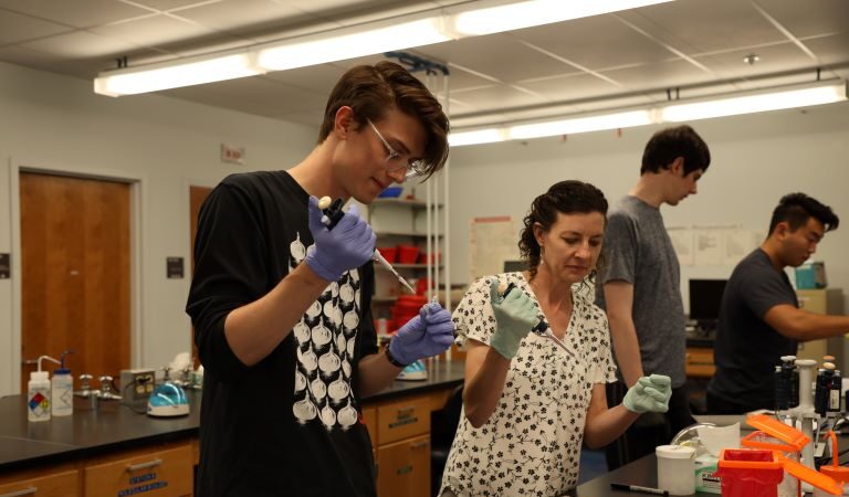 Student and teacher in chem lab working on Chem research