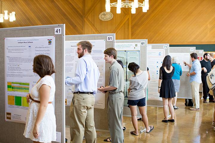 HMC student researchers reviewing project posters