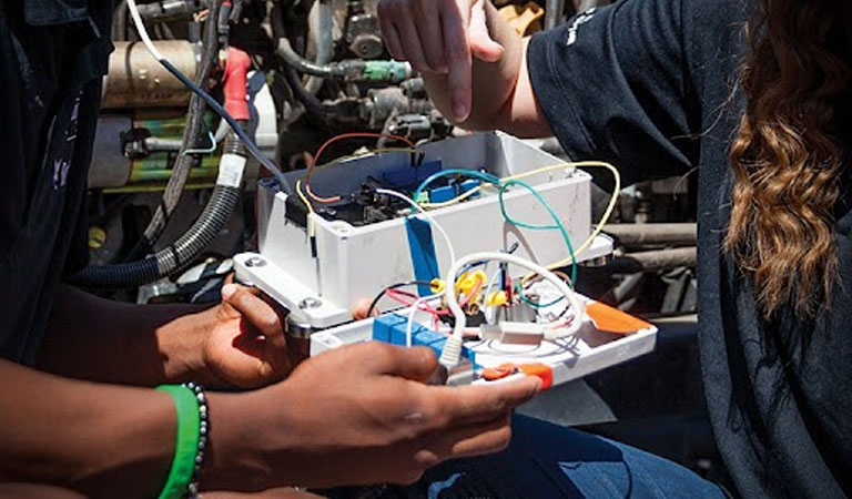 hands working with computer wiring