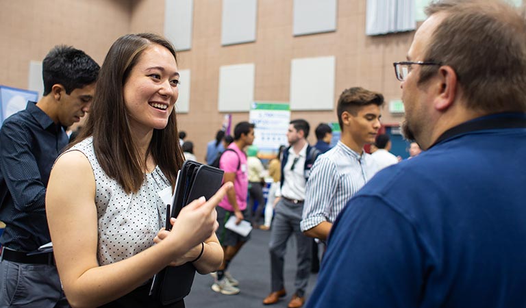 Student talking to recruiter.