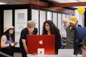 Aashita Kesarwani and Jon Ebueng showing attendees how to use generative AI coding tools.