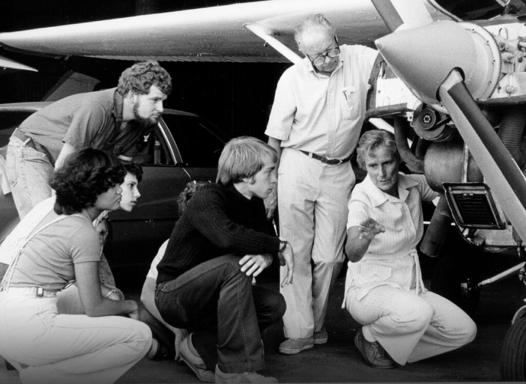 Iris Critchell talks to students as they inspect a small aircraft